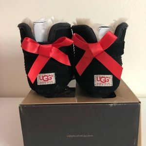 Toddler Ugg boot with red bows and “red bottoms”